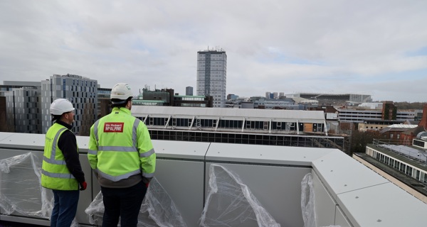 Two construction professionals taking in the view from the top of NESST