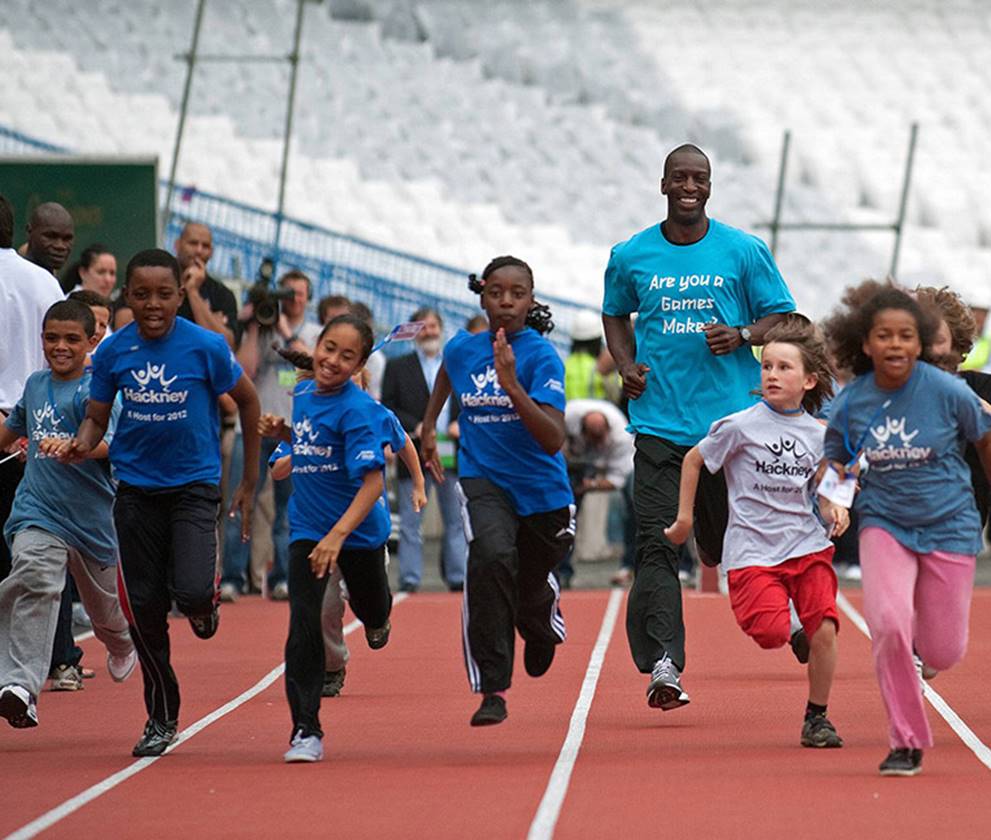 Children running on race track at Olympic Stadium