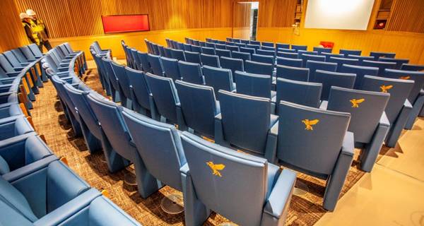 auditorium with seating showing pegasus symbol