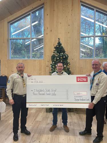 3 members of Knutsford Scouts with Strong Foundations 2022 cheque