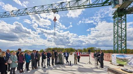 Guests with crane in background at NRC topping out