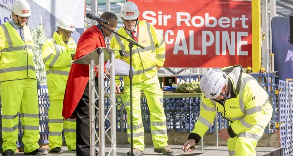 The final cement is poured to signify the topping out