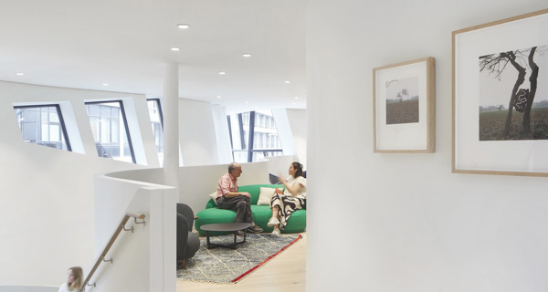 The Maggie's Centre interior with undulating walls and natural light filtering through unique window shapes.