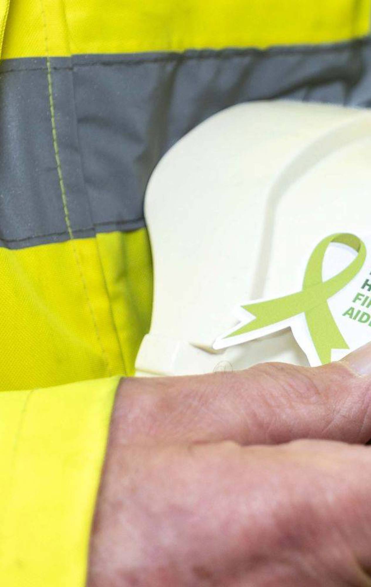 hard hat with a mental health first aider sticker