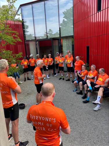 The Tour de Netherlands cyclists sitting and chatting as they prepare to depart London for Groningen.