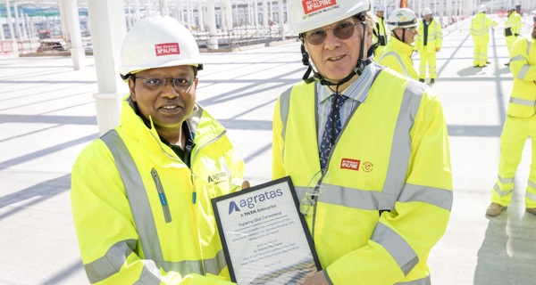 Sir Andrew McAlpine poses for a photograph with an Agratas team member
