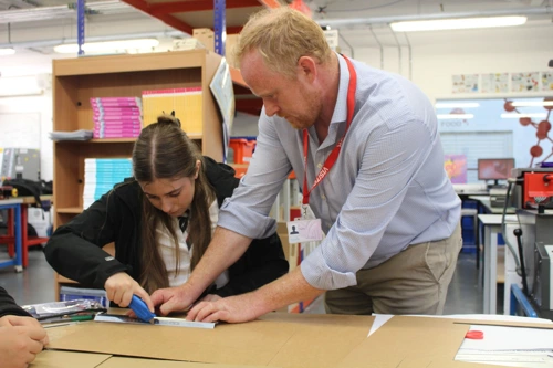 TQEC Project Director Peter Munn assists a student