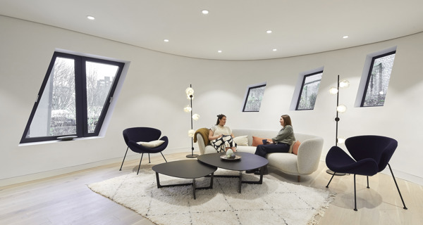 Women conversing at Maggie's Royal Free Hospital Centre, featuring calming and modern design elements.