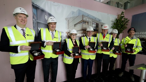 Delegates pose for a photo at NESST topping out