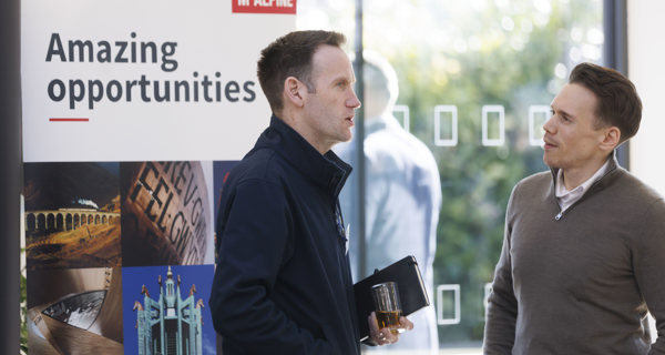 Local businesses interacting at exhibition stands.