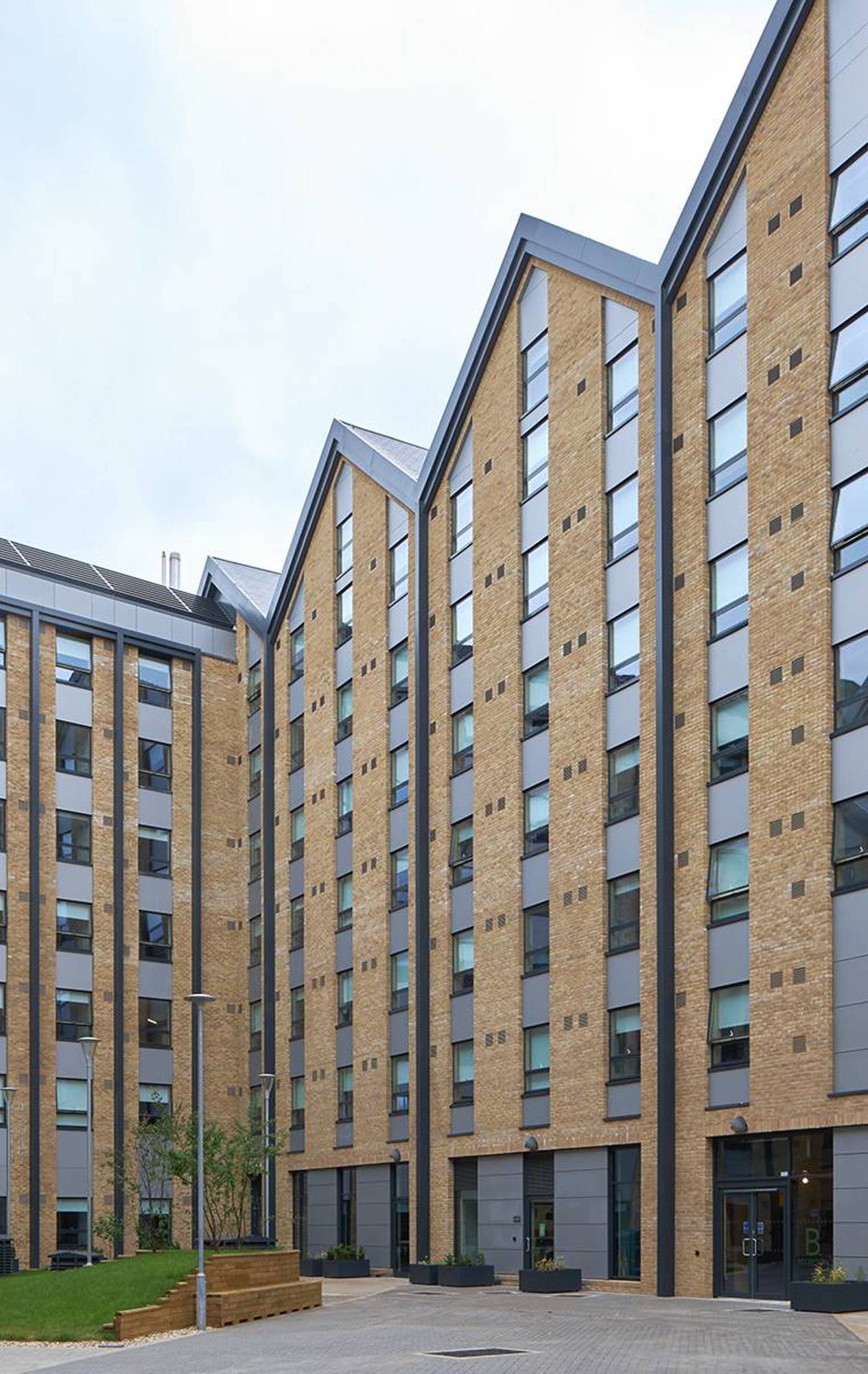 Street-level view of the building, highlighting the large glass shop fronts for retail and events spaces.