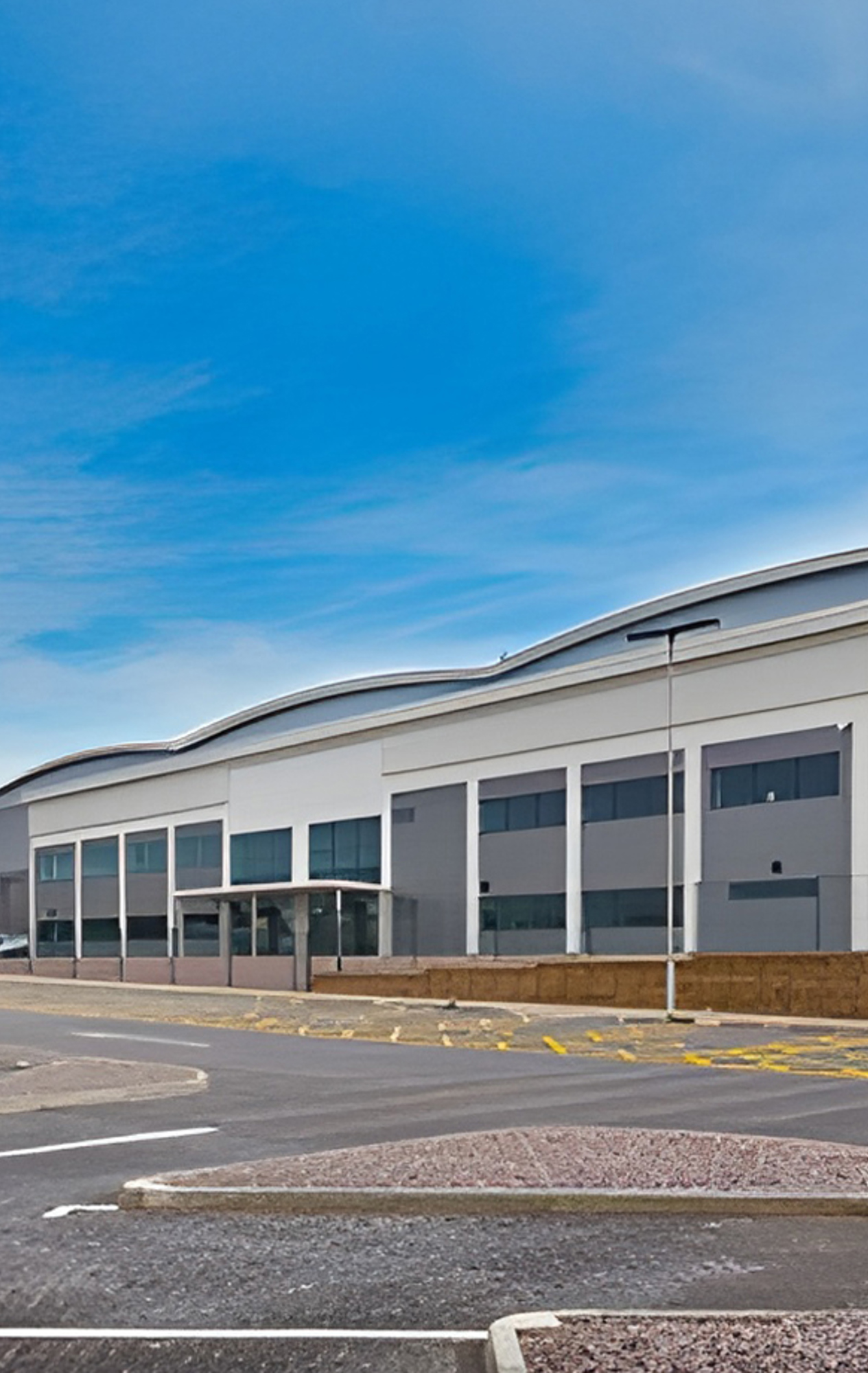 Wide-angle shot of warehouse exterior with HGV parking areas