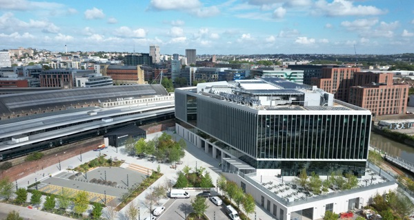 Exterior drone shot of TQEC against the backdrop of blue sky